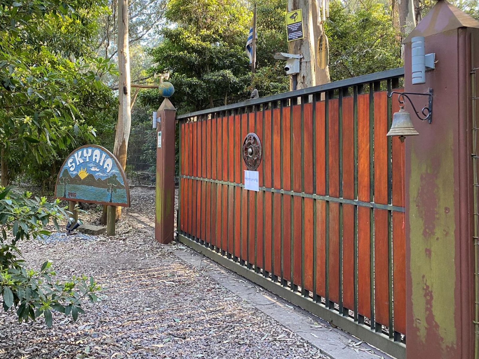 Skyaia entrance gate with wooden fencing and the sanctuary sign visible